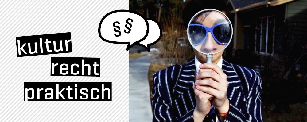Person with blue sunglasses looking through a magnifying glass
